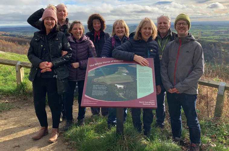 Dementia Forward members pose on a walk in the countryside