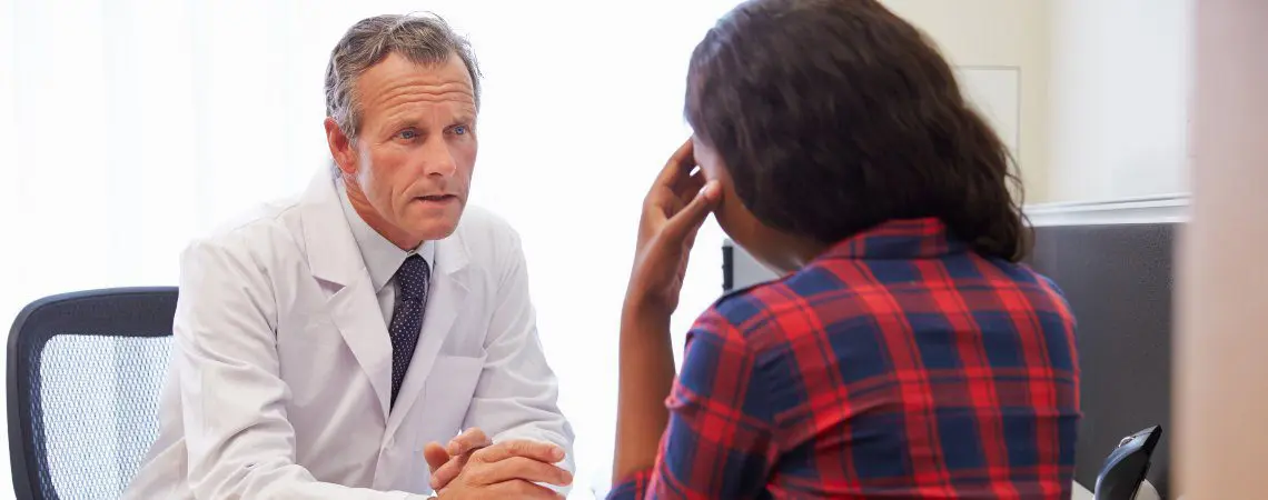 A clinician talks with a patient